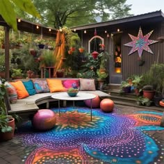 an outdoor patio with colorful rugs and potted plants