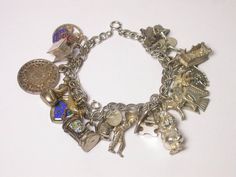 Vintage Sterling Silver Charm Bracelet Measures 7.5" Long Lake Tahoe Beer Stein Native American EagleSquirrel Donkey Eiffel Tower Illinois Deer Ship Three Leaf Clover Just to name a few charms Total weight: 65.1 Grams041813-1473FEEL FREE TO MESSAGE ME WITH A BEST OFFER OR IF YOU WISH TO SEE MORE PICTURES!Save money! We combine shipping where you pay only $1.00 more for any additional items on the same order!_________________________________________________________________________________________ Native American Eagle, Three Leaf Clover, Long Lake, Vintage Sterling Silver Charms, Sterling Silver Charm Bracelet, Beer Stein, Silver Charm Bracelet, Enamel Charms, Leaf Clover