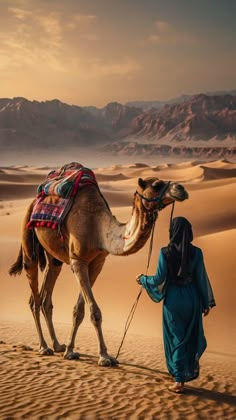 a woman walking with a camel in the desert