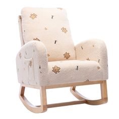 a white rocking chair with flowers on it's back and arms, in front of a white background