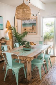 a dining room table with blue chairs and a bowl of fruit on top of it