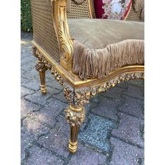 an ornately decorated chair with fringed cushions on it's back and sides