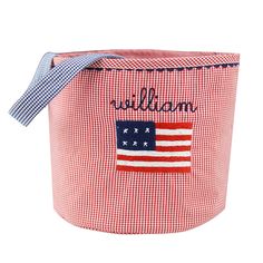 a red and white gingham basket with an american flag on the side, that says