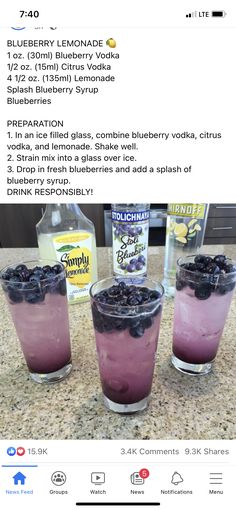 three glasses filled with blueberries on top of a counter