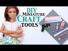 a doll with her arms crossed next to craft supplies