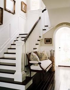 the stairs in this house have been painted white and are decorated with black and white accents