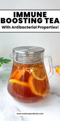 a pitcher filled with liquid and sliced oranges