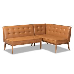 a brown leather couch sitting on top of a white floor next to a wooden frame