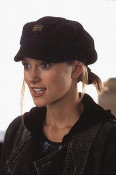 a woman with ponytails wearing a black hat