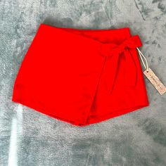 New With Tags Size Small Bright Red Skort Side Bow Full Elastic Waistband Waist Measurements: Approximately 13.5 Inches ( Does Stretch More) Length: 11.5 Inches Inseams: 2 Inches Solid Summer Party Shorts, Solid Color Party Shorts For Summer, Casual Solid Color Shorts For Party, Red High-waisted Shorts For Party, Chic Solid Color Beach Shorts, Stretch Red Bottoms For Day Out, Chic Red Shorts For Spring, Chic Red Spring Shorts, Trendy Red Summer Shorts