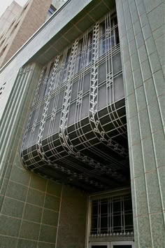 a building with a clock on the side of it's front door and windows