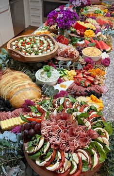 a long table filled with lots of different types of food on top of each other