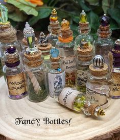 many small glass bottles with cork tops on a table