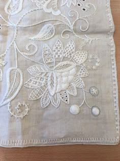 an embroidered cloth with white flowers on it