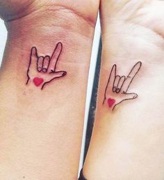 two small wrist tattoos with hands and hearts on them