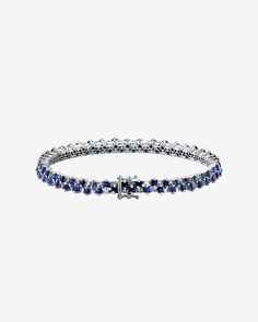 Our dark blue sapphire tennis bracelet has been beautifully set with a double layer of alternating princess cut dark blue sapphires and sparkling baguette white diamonds. Exquisite is the best way to describe it. This is the thinner version of the Colette tennis bracelet Details 18k white gold, rose gold or yellow 4.08 carats of 2x2mm princess-cut dark blue sapphires 0.95 carats of baguette white diamonds 4.5 mm width 7 in length Ref: AKB434 Sapphire Tennis Bracelet, Baguette Bracelet, Model Workout, Diamonds Bracelet, Vs Diamond, Box Clasp, Baguette Diamond, Blue Bracelet, Sapphire Diamond