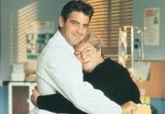 a man and woman hugging each other in a hospital room with medical equipment behind them