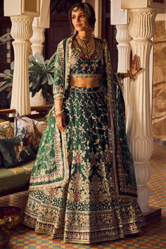 Featuring a bottle green lehenga in net base with zari, stone, thread hand embroidery, including a shantoon inner. It is paired with a matching top having a shantoon inner and a dupatta.The Wedding Carnival up to 80 % off tie the knot in dreamy masterpieces. #Perniaspopupshop #womenswear #ethnic #whatiworewastrending #ppuslove #lehengaset #prewedding #shantoon #net #stoneembroidery #threadwork #zariembroidery #weddingwear #engagement #sangeet #embroideredlehenga #bridallook Bridal Lehenga Online, Ivory Blouse, Lehenga Skirt, Lehenga Saree, Bottle Green, Bridal Lehenga