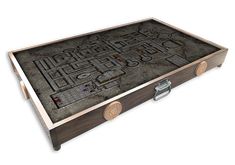 a wooden box with a maze design on it