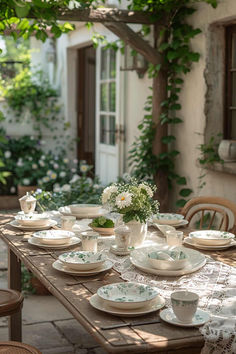 the table is set with dishes and cups