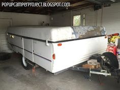 a trailer is parked in a garage with other items