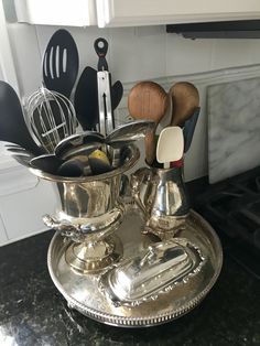 an assortment of kitchen utensils on a silver plate