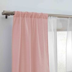 pink curtains hanging on the side of a window