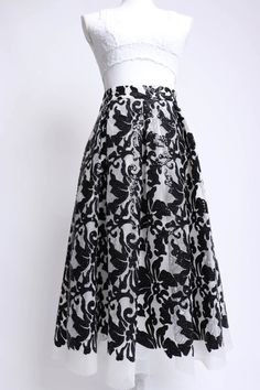 Description: Eliza J 00's black and white sequin mesh floral patterned midi skirt This skirt was designed with comfort in mind Features a soft lined waist with a hidden zipper and black elastic inserts on either side The white polyester mesh is soft and squishy and decorated with little black sequins in a pretty floral pattern The pleated waist gives way to a full skirt, and it has silky lined pockets Fully lined in white polyester fabric Model is 5'11" Waist 29" Hips 40" Length 30" Details: Siz Long Black Sequined Skirt, Black Long Sequin Skirt, Glamorous Black Spring Skirt, Elegant Black Skirt With Contrast Sequin, Black Sequined Skirt For Spring, Spring Black Sequin Skirt, Formal Black Sequin Skirt, Patterned Midi Skirt, Mesh Midi Skirt