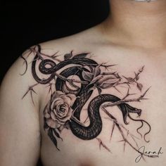 a man's chest with a snake and rose tattoo design on his left side