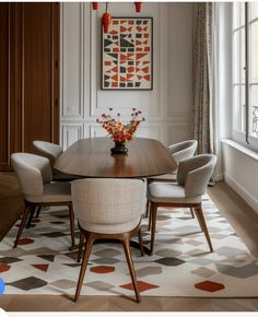 a dining room table surrounded by chairs