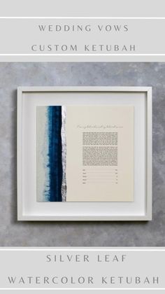 the wedding vows and custom ketubah are displayed in a white frame with blue watercolor