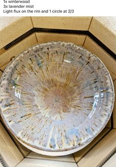 a dirty white bowl sitting on top of a tiled floor