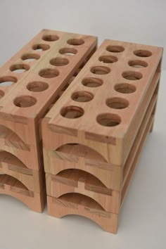 three wooden blocks with holes in them