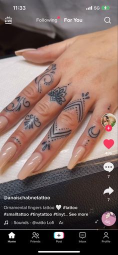 a woman's hand with tattoos on it