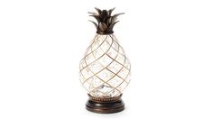 a pineapple shaped glass lamp on a wooden base with an intricate wire work design