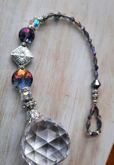 the necklace is made up of many different colored beads and glass beads, with an intricate design on it