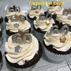 cupcakes with white frosting and silver numbers on them