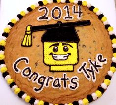 a decorated cookie with the words congrats five and a graduation cap on it