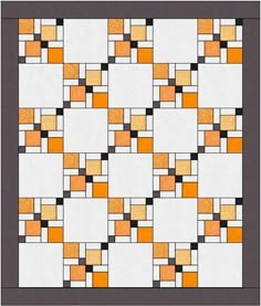 an orange and white quilt with squares in the center, on top of a gray background