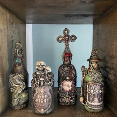 there are many bottles on the shelf with skulls and crosses in them, as well as an iron cross