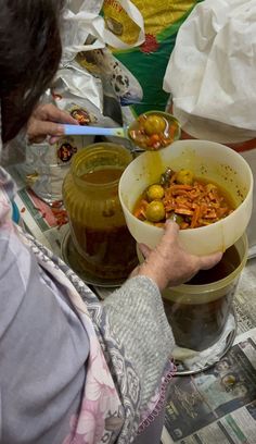 a woman holding a bowl of food in her hands