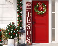 a red door decorated with christmas wreaths and decorations, next to a holiday sign