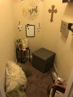 a small room with a bench and some decorations on the wall