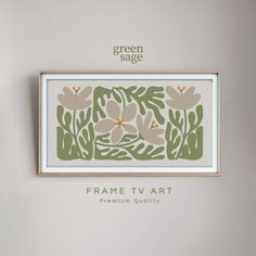 the frame tv art is hanging on the wall next to a vase with flowers in it