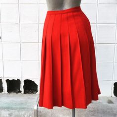 Waist 26 inches Length 26 inches Beautiful, bright red. Excellent condition. Unlined. Wool. Classic Red Skirt, Red Pleated Flared Skirt, Red Knee-length Pleated Skirt For Spring, Red Retro Pleated Skirt, Red Pleated Knee-length Skirt, Retro Red Pleated Bottoms, Retro Red Pleated Skirt, Retro Knee-length Pleated Skirt, Red Pleated A-line Skirt