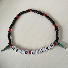 Weed Queen Black Beaded Hemp Logo Bracelet With Leaf And Red Accents This Beaded Statement Bracelet Is Essential For The Spring And Summer Time Season It Is A Must Have For Anyone Who Loves Jewelry And Beautiful Accessories Hand Crafted With Durable Stretchy Elastic Cord And Hypoallergenic Materials This Bracelet Would Be Great To Wear On Vacation Or For Date Night Modern With A Touch Of Elegance The Jewelry Would Make A Wonderful Gift For Yourself Or Someone You Care About Each Piece Is Rare An Pot Leaf Bracelet, Beaded Bracelets Boyfriend, Things To Write On Bracelets, Beaded Bracelets With Words, Matching Kandi Bracelets, Crochet Rave, Rave Bracelets, Queen Logo, Diy Kandi Bracelets