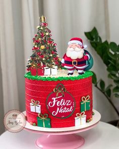 a cake decorated with santa clause and presents