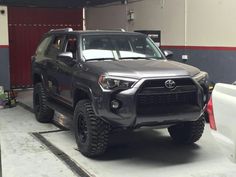 a gray toyota truck parked in a garage