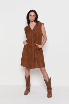 DECADE / 1970 MEASUREMENTS / Shoulder - 16" Bust - 20" Waist - 18" Hips - 23" Length - 37" Sleeve - 5" TAG / MARINA SHORT MATERIAL / Genuine Suede, thick structured suede, fully lined CONDITION / Great TAG SIZE / N/A FIT / Would look great on smaller sizes for an oversized fit. For reference, model is 5'8 and wears a size 2/4. *All Measurements are taken with garment lying flat. -------- VINTAGE ------- All items are vintage and therefore occasionally may have some minimal wear consistent with t Casual Fitted Vintage Dress For Fall, Retro Brown Dress For Fall, Classic Sleeveless Vintage Dress, Retro Brown Dress With Buttons, Sleeveless Vintage Dress For Fall, Brown Vintage Dress For Fall, Brown Vintage Dress For Spring, Fitted Sleeveless Vintage Dress For Fall, Fall Vintage Brown Dress