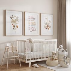 a baby's room with three framed pictures on the wall and a crib